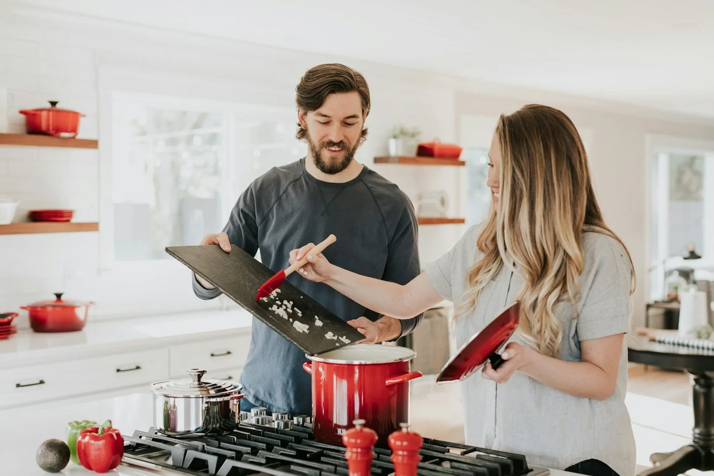 Two people preparing ingredients together at a kitchen counter.